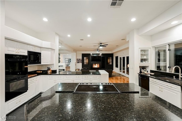 2231 S Tioga Way, Las Vegas, NV 89117 - kitchen featuring black appliances, a sink, a peninsula, white cabinetry, and a ceiling fan