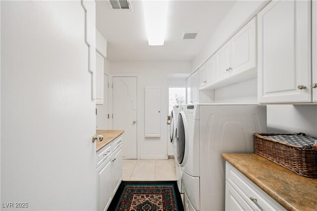 2231 S Tioga Way, Las Vegas, NV 89117 - laundry area featuring cabinet space, washing machine and clothes dryer, and light tile patterned floors
