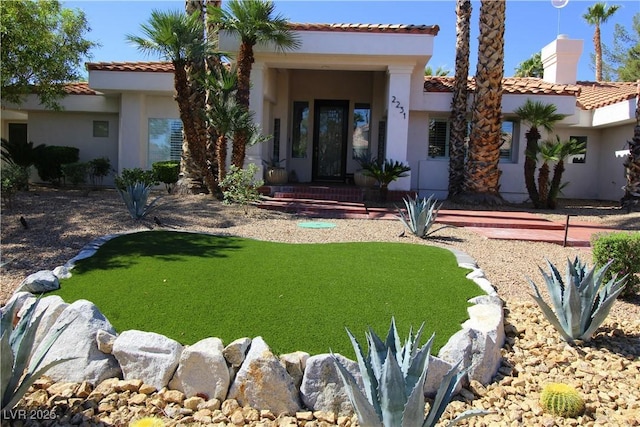 2231 S Tioga Way, Las Vegas, NV 89117 - view of front facade with a tile roof, a chimney, stucco siding, and a front yard