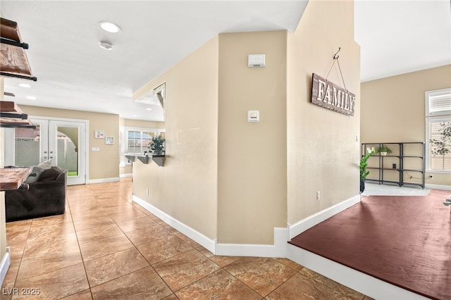 2021 Summit Pointe Dr, Las Vegas, NV 89117 - corridor featuring plenty of natural light, french doors, baseboards, tile patterned floors, and recessed lighting