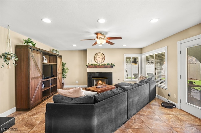 2021 Summit Pointe Dr, Las Vegas, NV 89117 - living area with ceiling fan, recessed lighting, a glass covered fireplace, and baseboards