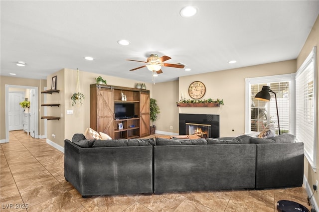 2021 Summit Pointe Dr, Las Vegas, NV 89117 - living area featuring a glass covered fireplace, baseboards, ceiling fan, and recessed lighting