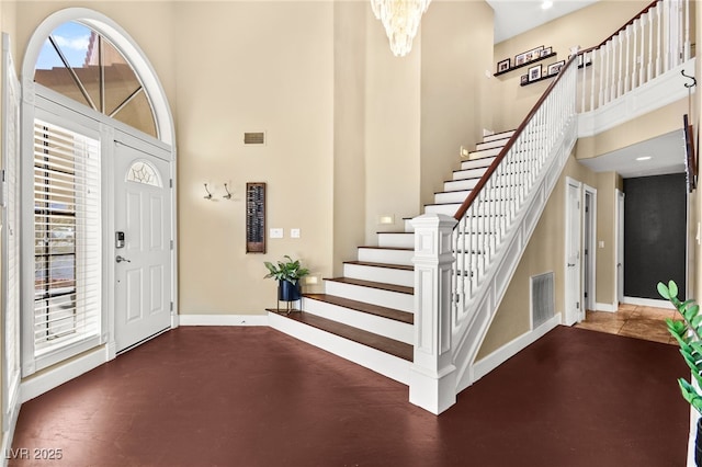 2021 Summit Pointe Dr, Las Vegas, NV 89117 - entrance foyer featuring a high ceiling, stairs, baseboards, and a chandelier