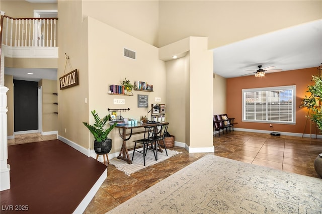 2021 Summit Pointe Dr, Las Vegas, NV 89117 - office area with a towering ceiling, ceiling fan, baseboards, and tile patterned flooring