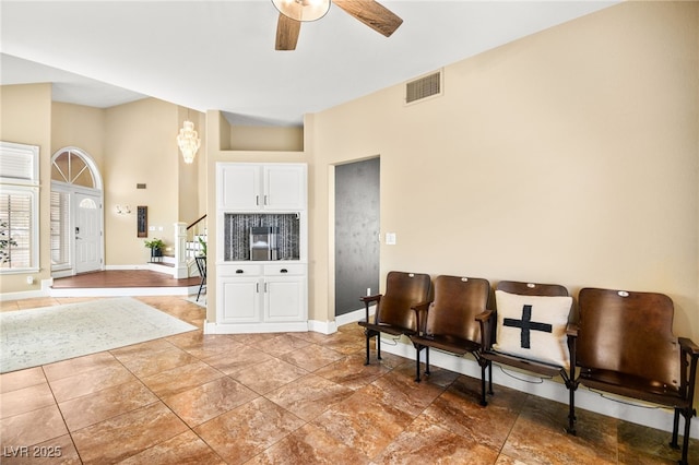 2021 Summit Pointe Dr, Las Vegas, NV 89117 - living area with a ceiling fan, a towering ceiling, baseboards, and stairs