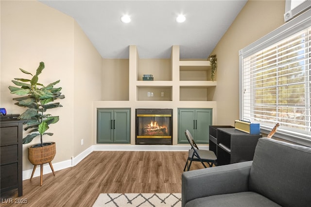 2021 Summit Pointe Dr, Las Vegas, NV 89117 - living area featuring lofted ceiling, wood finished floors, a glass covered fireplace, baseboards, and recessed lighting