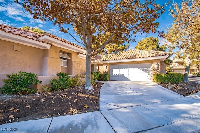 4911 Mount Pleasant Ln, Las Vegas, NV 89113 - view of front facade with a tile roof, stucco siding, driveway, and an attached garage