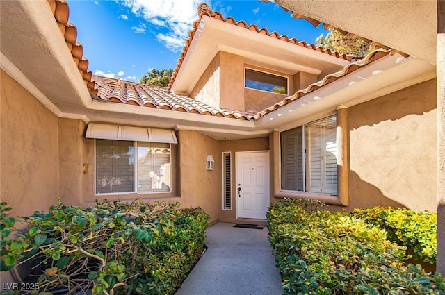 4911 Mount Pleasant Ln, Las Vegas, NV 89113 - view of exterior entry featuring a tile roof and stucco siding