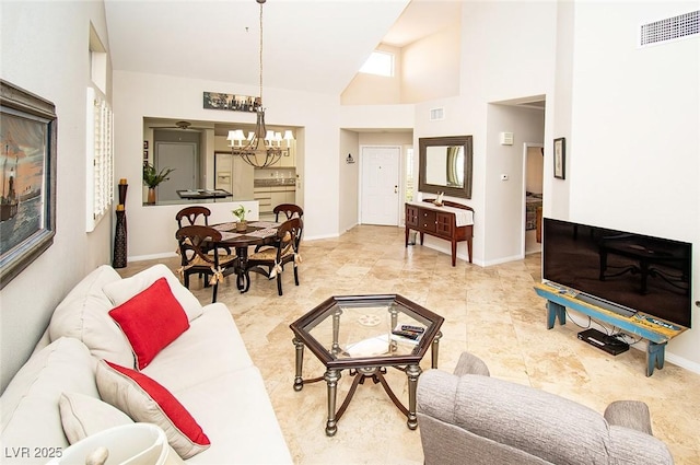 4911 Mount Pleasant Ln, Las Vegas, NV 89113 - living area featuring a chandelier, baseboards, and vaulted ceiling