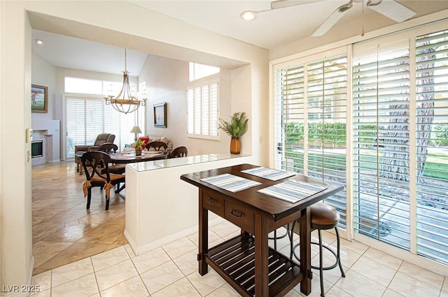 4911 Mount Pleasant Ln, Las Vegas, NV 89113 - dining space featuring a chandelier, a ceiling fan, light tile patterned floors, and lofted ceiling