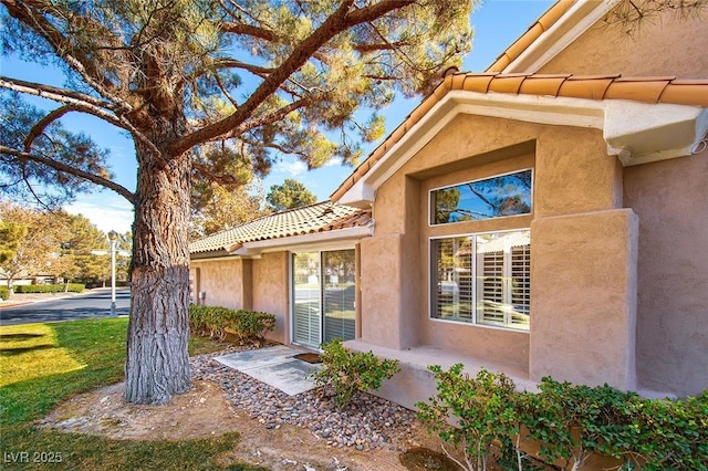 4911 Mount Pleasant Ln, Las Vegas, NV 89113 - view of exterior entry featuring stucco siding and a tiled roof