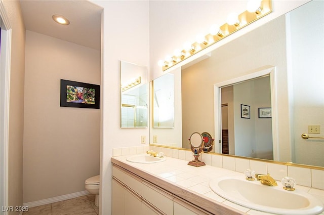 4911 Mount Pleasant Ln, Las Vegas, NV 89113 - bathroom featuring toilet, double vanity, and baseboards