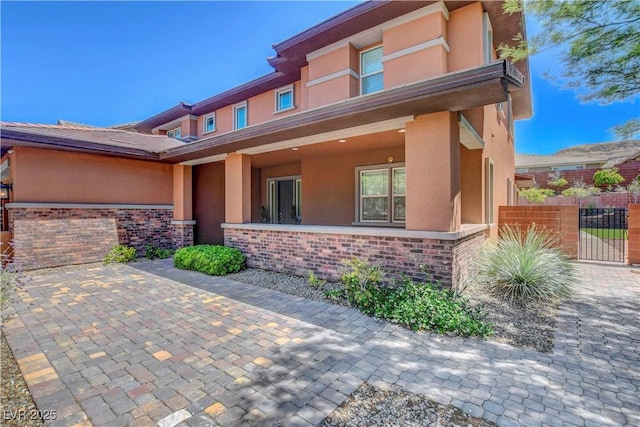 10433 Ember Rose Ave, Las Vegas, NV 89135 - view of front of house with stucco siding, brick siding, and stone siding