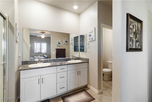 42 Late Harvest Ave, Pahrump, NV 89060 - bathroom featuring double vanity, toilet, ceiling fan, baseboards, and a shower with door