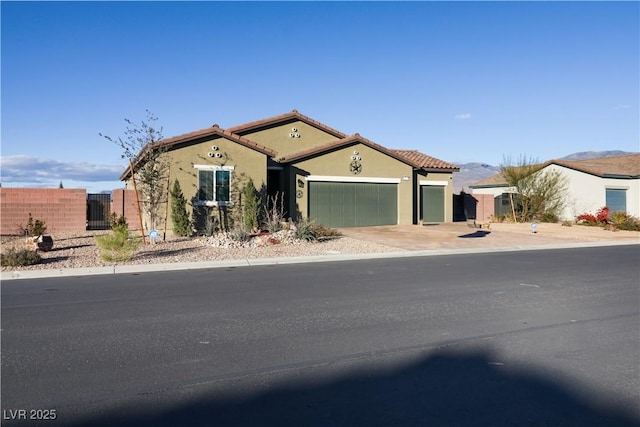 42 Late Harvest Ave, Pahrump, NV 89060 - mediterranean / spanish-style house with an attached garage, stucco siding, a tile roof, and a gate
