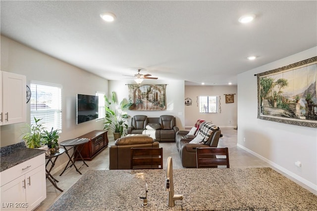 42 Late Harvest Ave, Pahrump, NV 89060 - living room with healthy amount of natural light, ceiling fan, baseboards, recessed lighting, and light tile patterned floors