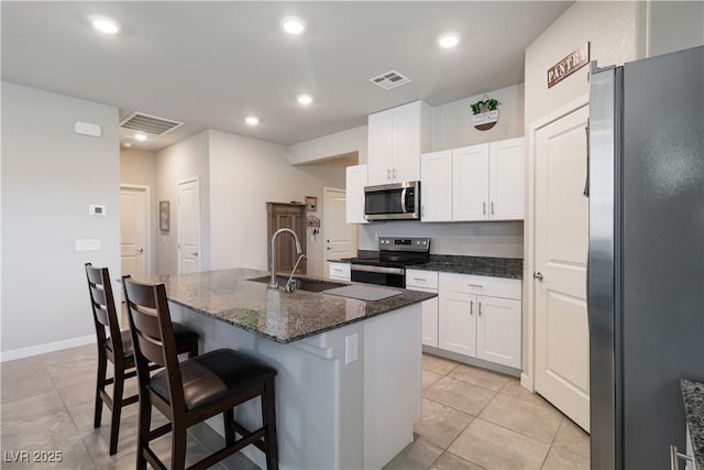 42 Late Harvest Ave, Pahrump, NV 89060 - kitchen with stainless steel appliances, white cabinets, a sink, a center island with sink, and a kitchen bar