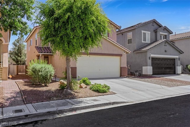 5321 Welch Valley Ave, Las Vegas, NV 89131 - view of front of home featuring a tiled roof, concrete driveway, and stucco siding