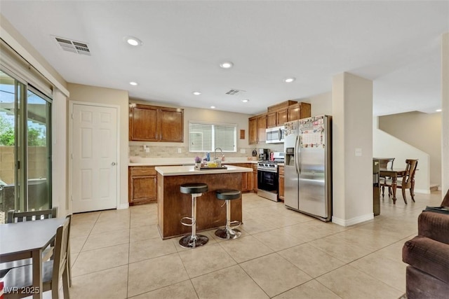 5321 Welch Valley Ave, Las Vegas, NV 89131 - kitchen featuring appliances with stainless steel finishes, plenty of natural light, a kitchen island, light countertops, and recessed lighting