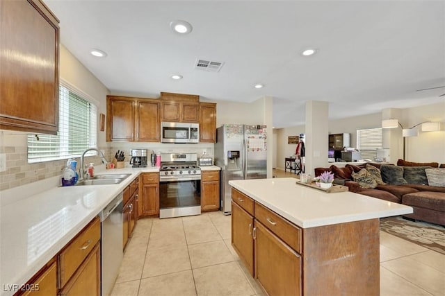 5321 Welch Valley Ave, Las Vegas, NV 89131 - kitchen with stainless steel appliances, a sink, open floor plan, decorative backsplash, and recessed lighting