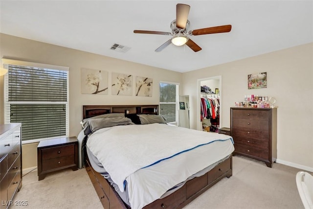 5321 Welch Valley Ave, Las Vegas, NV 89131 - bedroom featuring light colored carpet, a walk in closet, a closet, baseboards, and a ceiling fan