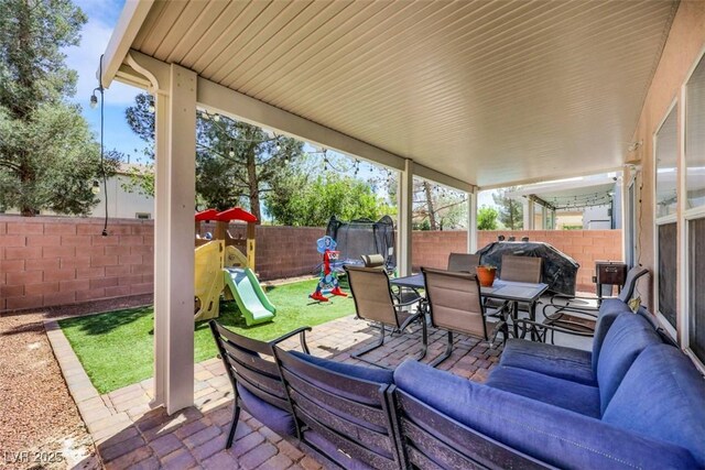 5321 Welch Valley Ave, Las Vegas, NV 89131 - fenced backyard featuring outdoor dining space, a patio, a playground, and outdoor lounge area