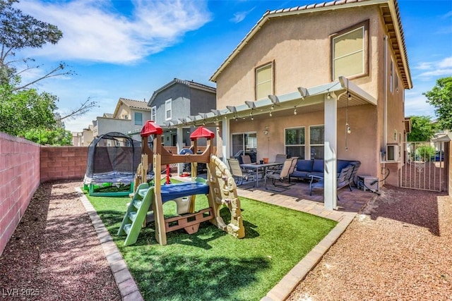 5321 Welch Valley Ave, Las Vegas, NV 89131 - back of house featuring stucco siding, a trampoline, an outdoor hangout area, and a patio