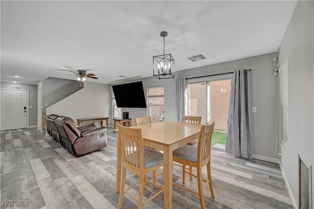 687 Porchtown Ave, Las Vegas, NV 89183 - dining room with light wood finished floors, ceiling fan, baseboards, and a chandelier
