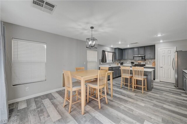687 Porchtown Ave, Las Vegas, NV 89183 - dining space featuring light wood-style floors, a chandelier, baseboards, and recessed lighting