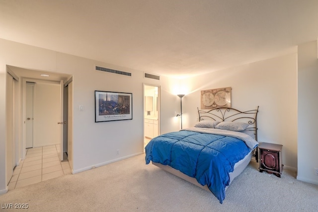 3111 Bel Air Dr Unit 23A, Las Vegas, NV 89109 - bedroom with light carpet, ensuite bathroom, baseboards, and light tile patterned flooring