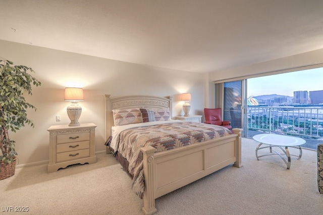 3111 Bel Air Dr Unit 23A, Las Vegas, NV 89109 - bedroom featuring light colored carpet, access to outside, and baseboards