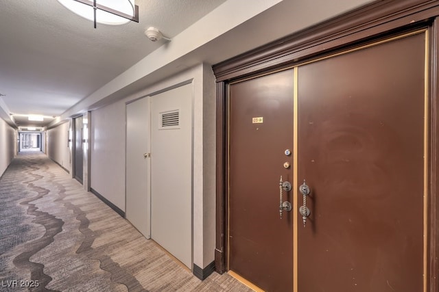 3111 Bel Air Dr Unit 23A, Las Vegas, NV 89109 - hallway featuring light colored carpet and baseboards