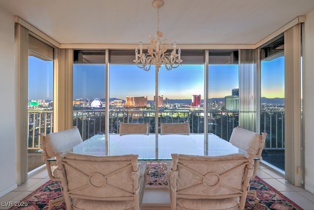 3111 Bel Air Dr Unit 23A, Las Vegas, NV 89109 - dining space featuring a chandelier, light tile patterned floors, and a city view