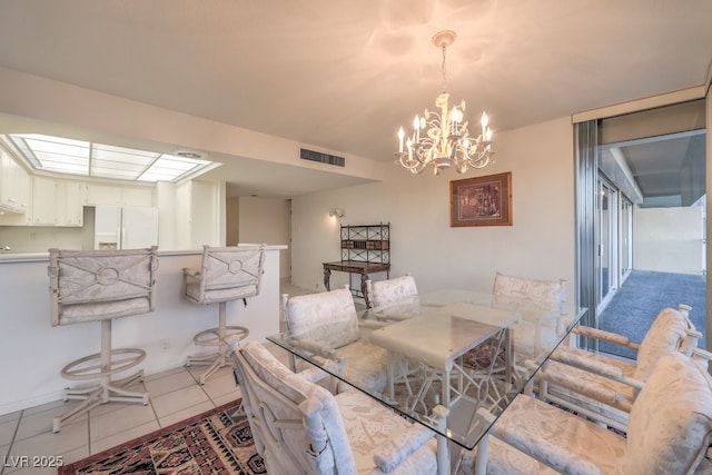 3111 Bel Air Dr Unit 23A, Las Vegas, NV 89109 - dining area with a chandelier, light tile patterned floors, and baseboards