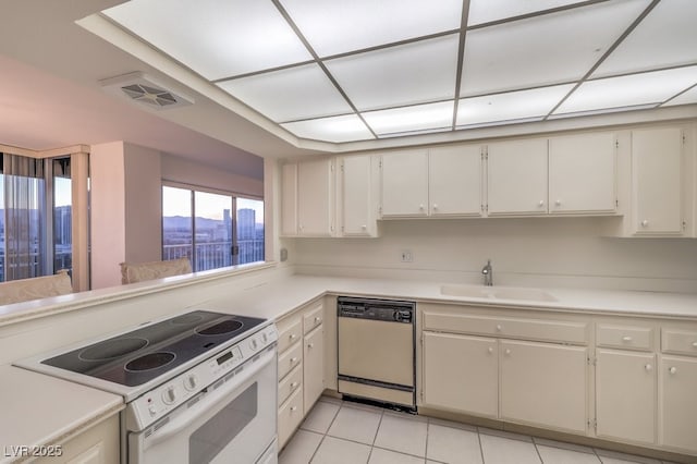 3111 Bel Air Dr Unit 23A, Las Vegas, NV 89109 - kitchen with dishwasher, white electric range, a sink, and light countertops