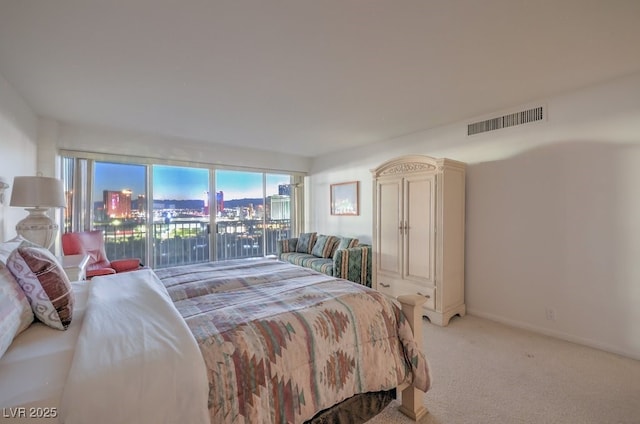 3111 Bel Air Dr Unit 23A, Las Vegas, NV 89109 - bedroom featuring light carpet and a view of city