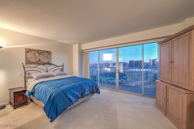 3111 Bel Air Dr Unit 23A, Las Vegas, NV 89109 - bedroom featuring light colored carpet, access to outside, and a city view