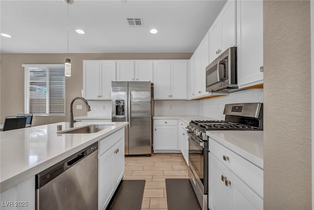 688 Monroe Hill Pl, Henderson, NV 89011 - kitchen with stainless steel appliances, a sink, backsplash, light countertops, and white cabinets