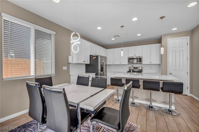 688 Monroe Hill Pl, Henderson, NV 89011 - dining room with baseboards, light wood-style floors, and recessed lighting