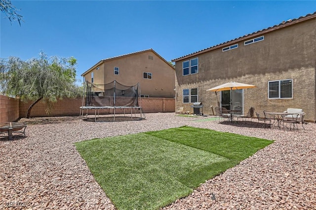8252 Pearl Oasis Ct, Las Vegas, NV 89139 - view of yard featuring a trampoline and a patio