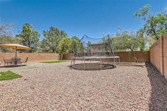 8252 Pearl Oasis Ct, Las Vegas, NV 89139 - fenced backyard featuring a trampoline