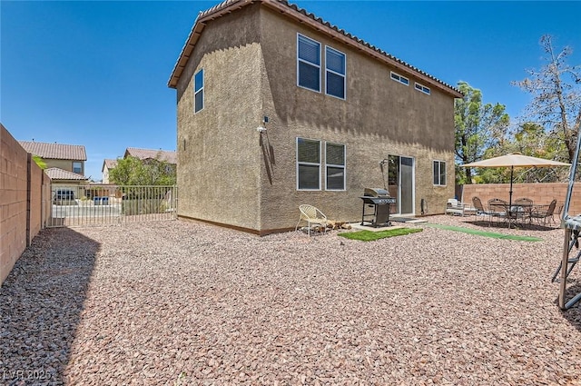 8252 Pearl Oasis Ct, Las Vegas, NV 89139 - back of property with stucco siding, a fenced backyard, a patio, and a tiled roof