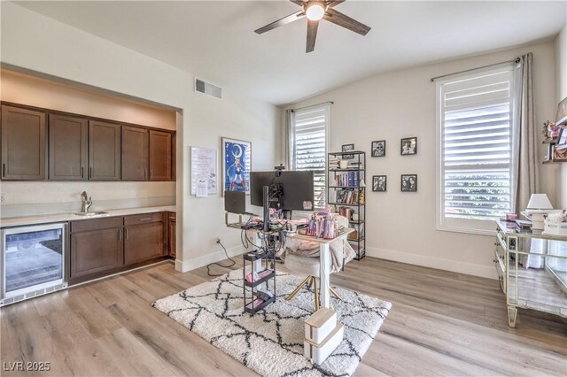 9655 Skye Star Ave, Las Vegas, NV 89166 - office area with beverage cooler, healthy amount of natural light, ceiling fan, light wood-type flooring, and lofted ceiling
