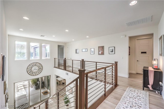 9655 Skye Star Ave, Las Vegas, NV 89166 - corridor with light wood-style flooring, recessed lighting, an upstairs landing, and baseboards