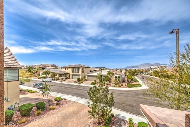 9655 Skye Star Ave, Las Vegas, NV 89166 - view of street with a residential view, street lighting, and a mountain view