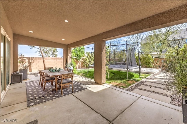 9655 Skye Star Ave, Las Vegas, NV 89166 - fenced backyard with a trampoline, a patio area, and outdoor dining area