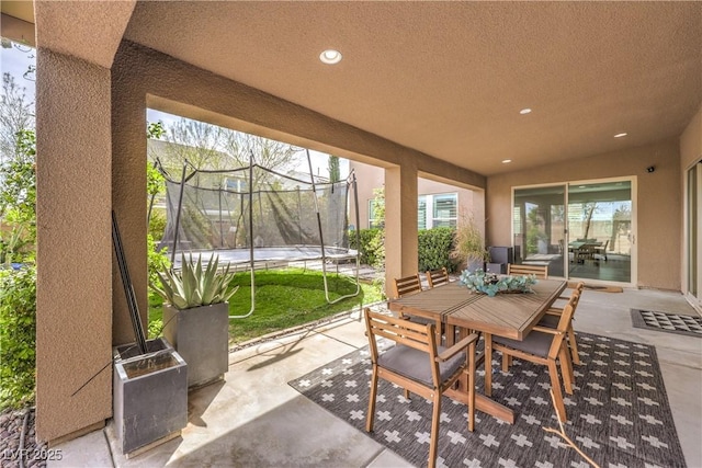 9655 Skye Star Ave, Las Vegas, NV 89166 - view of patio / terrace with a trampoline and outdoor dining area
