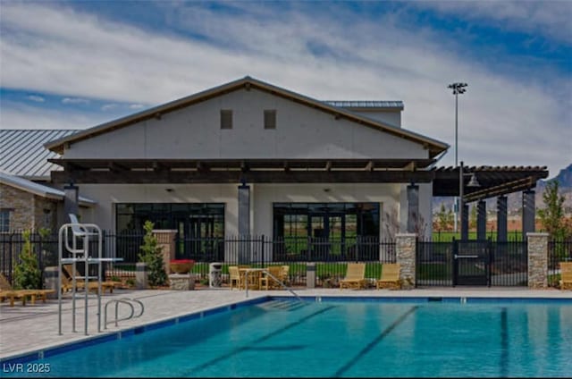 9655 Skye Star Ave, Las Vegas, NV 89166 - rear view of property featuring a community pool, a patio, and stucco siding