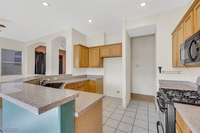 8849 Pheasant Valley Way, Las Vegas, NV 89123 - kitchen with black appliances, a sink, a peninsula, light countertops, and light tile patterned floors
