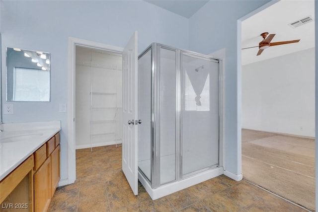 8849 Pheasant Valley Way, Las Vegas, NV 89123 - bathroom featuring a shower stall, vanity, a walk in closet, and a ceiling fan
